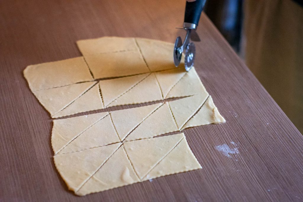Cutting the rolled out dough into rectangles.