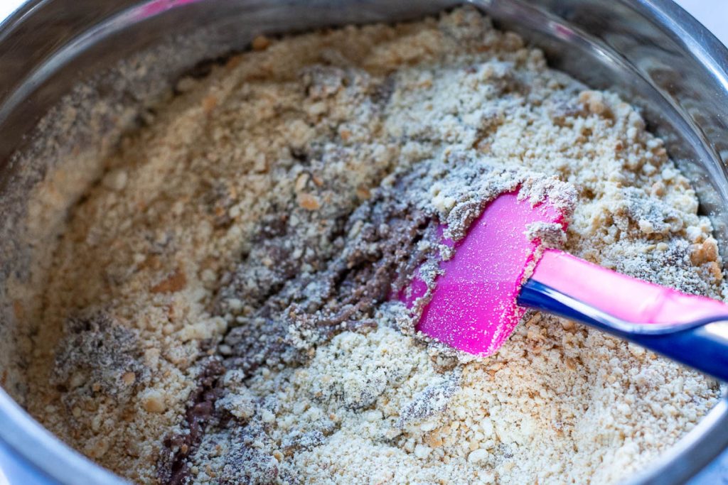 Crushed biscuits stirred into the wet ingredients.