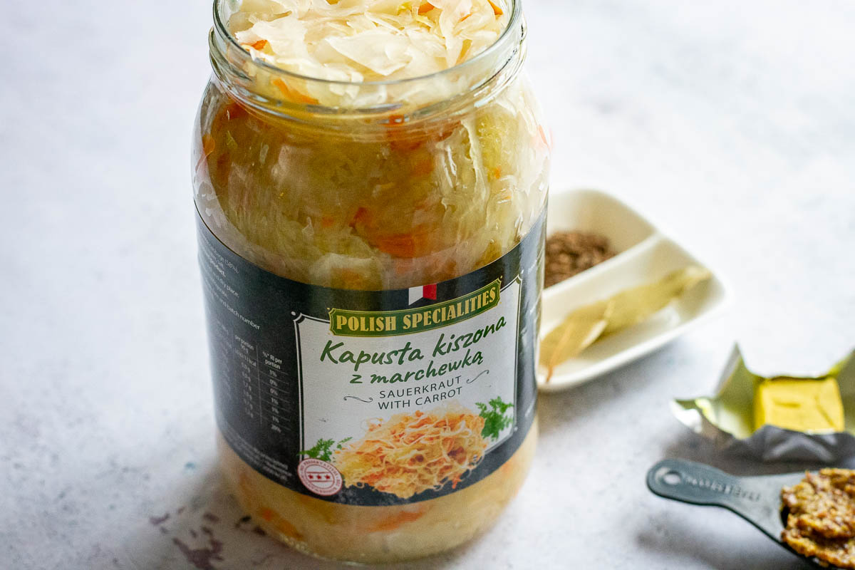 A large jar of Polish sauerkraut with carrots.