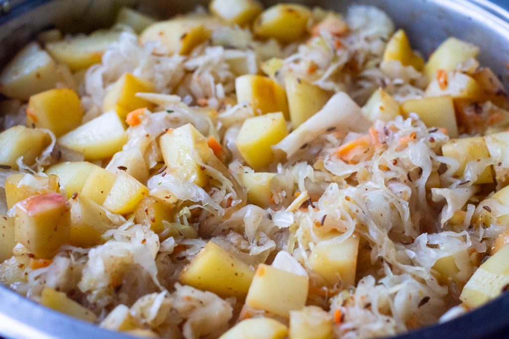 Sauerkraut and potato mixed in a large pan.