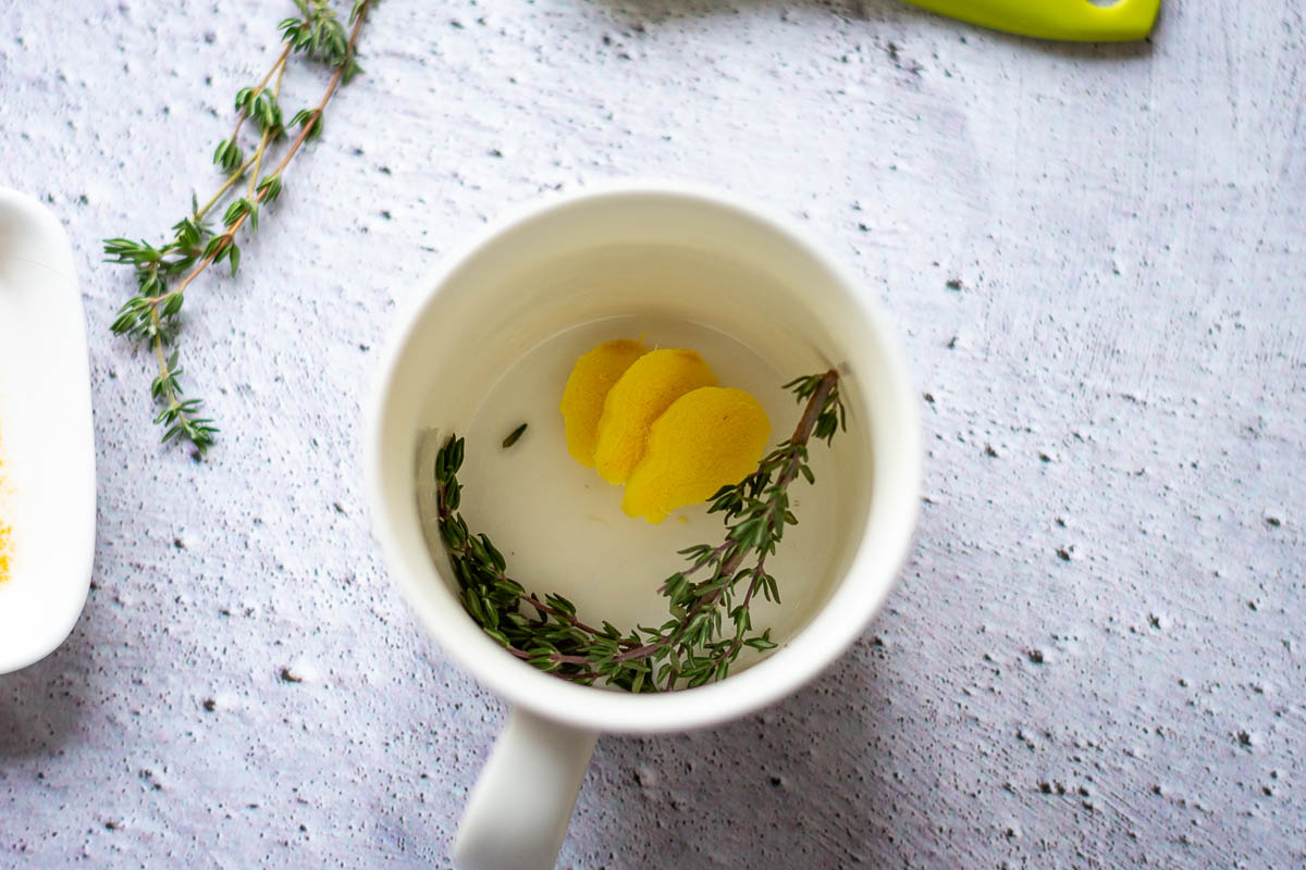 Ginger and thyme in a mug.