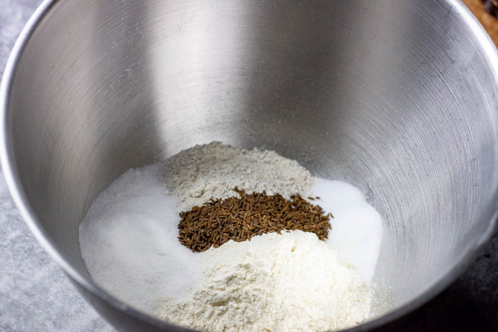 Dry ingredients for Lithuanian rye sourdough in a bowl of a stand mixer.