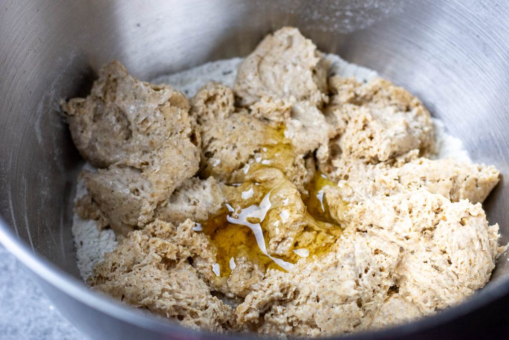 Stiff rye sourdough levain added to the stand mixer alongside, honey and water.