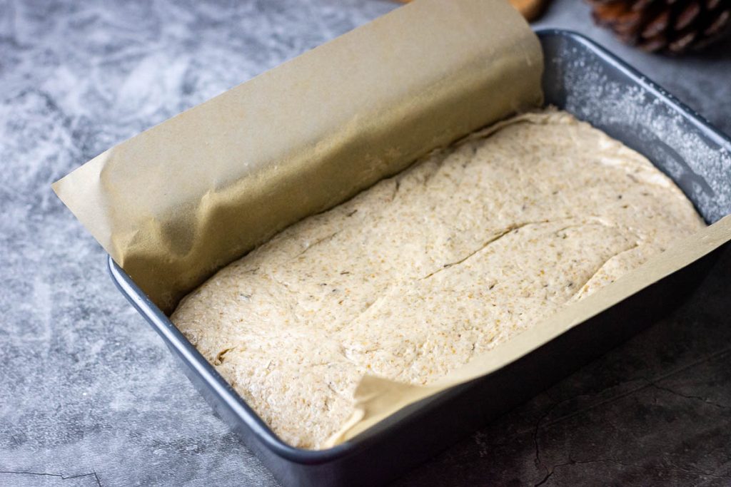 Rye bread dough in a loaf pan before second rise.