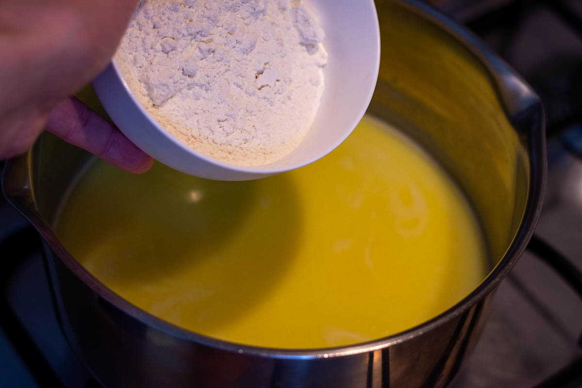 Flour being added to the butter and milk mixture.
