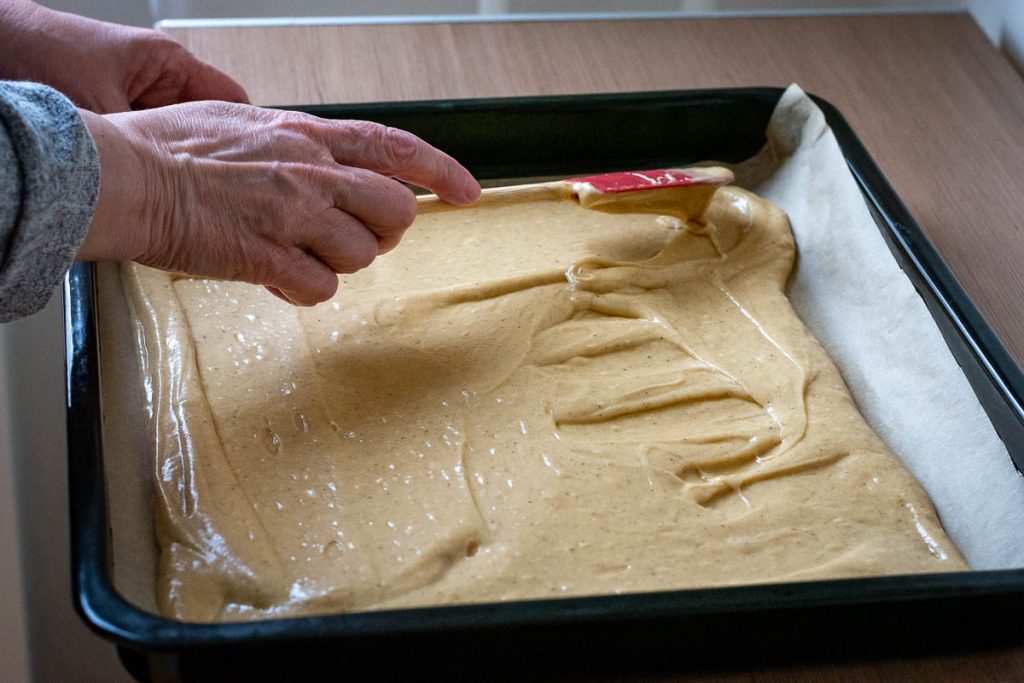 Evening out the cake batter into an even layer.
