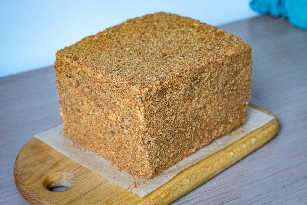 Fully assembled Lithuanain cake on a wooden board.