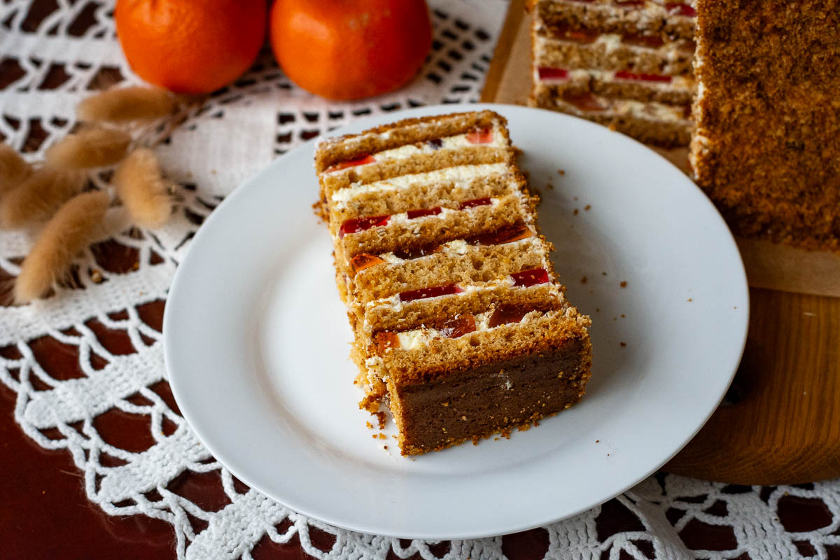 A slice of Lithuanian honey sponge cake on a small white plate.