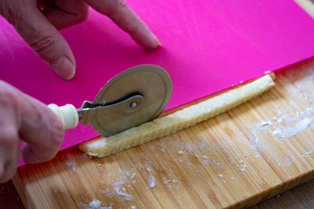 Cutting the straws with a pizza cutter. 