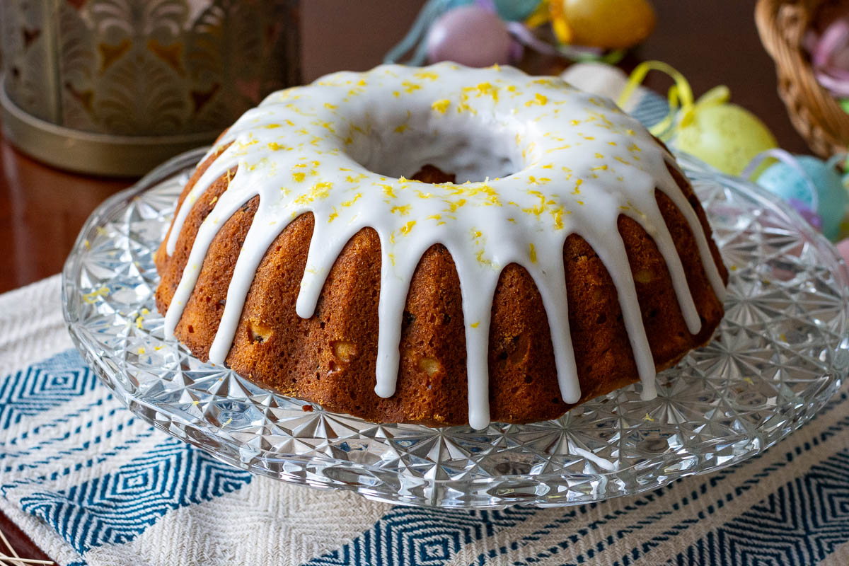 Lithuanian Easter Cake With Lemon Icing on a cake stand.