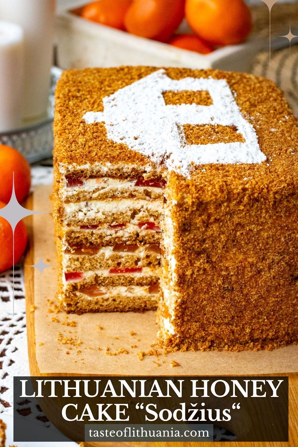 Lithuanian Honey Sponge Cake "Sodzius" with a piece cut exposing layers within. Pin for Pinterest.
