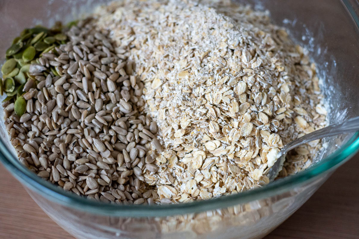 Seeds and oats added to the wet ingredients.