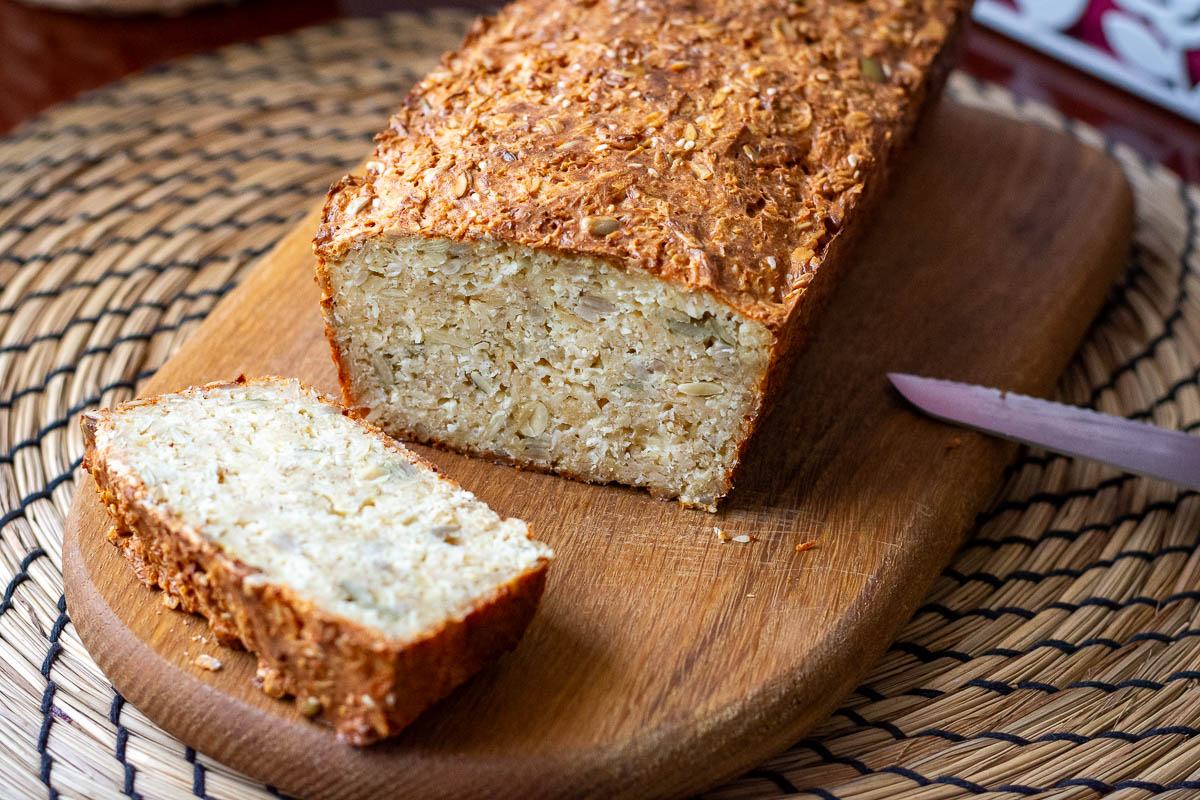 The first slice of Lithuanian seed and oat bread on cut from a loaf.