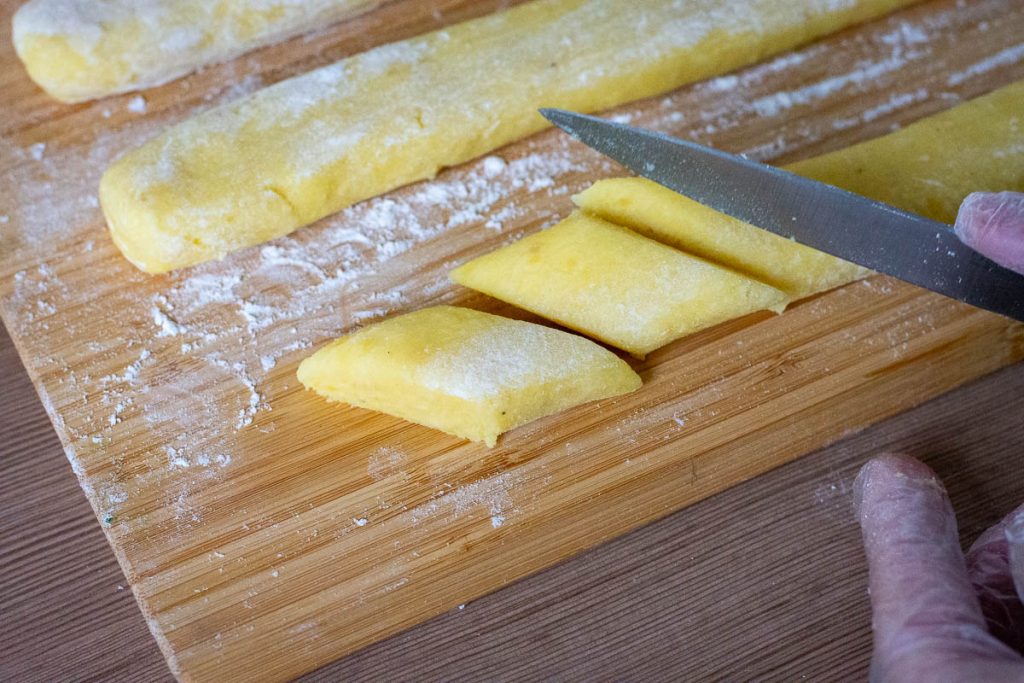 Cutting diamond shaped potato bites.