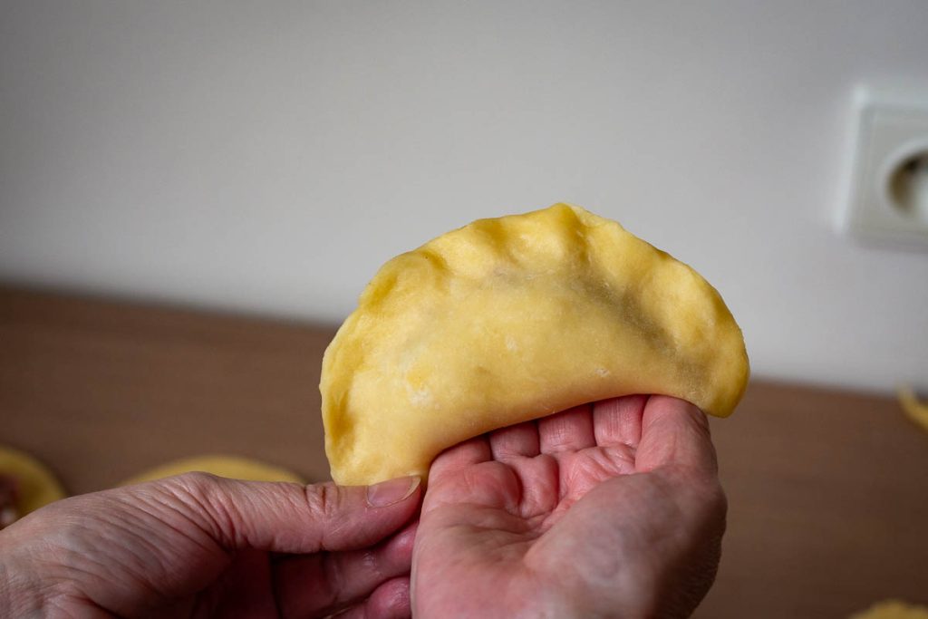 Pastry folded over the filling and egdes sealed.