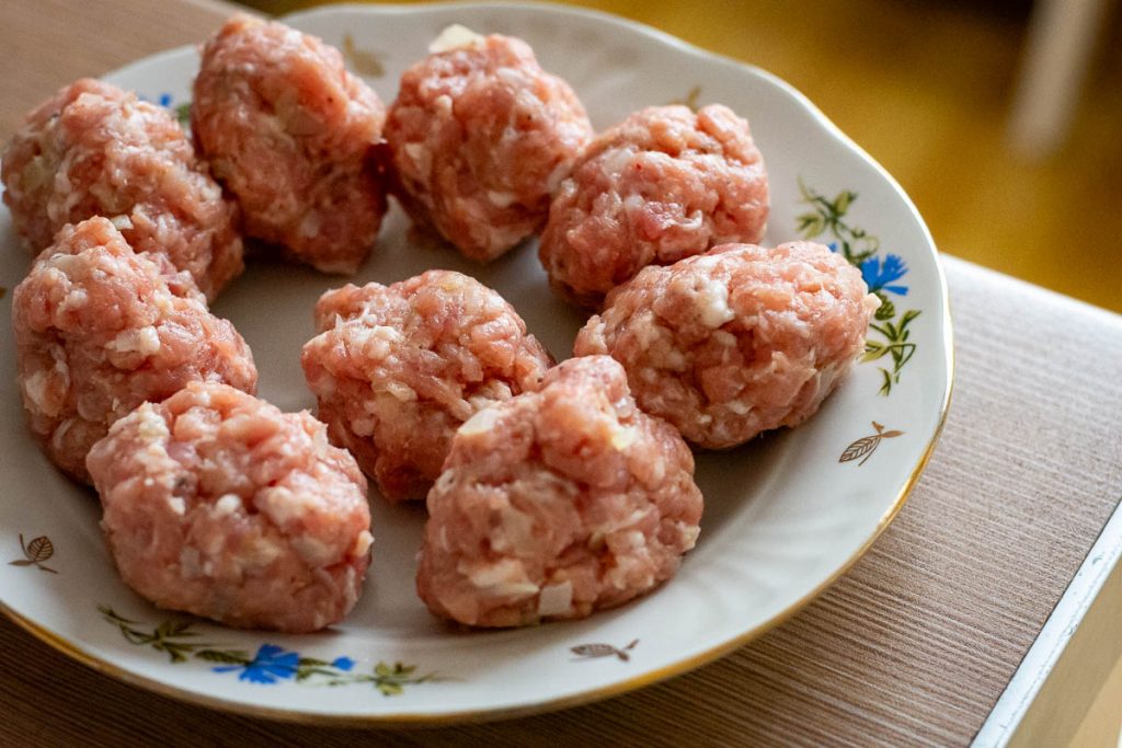 Pork filling divided into equal portions.