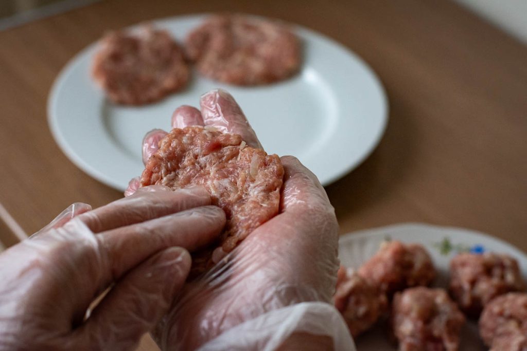 Forming ground pork patties.