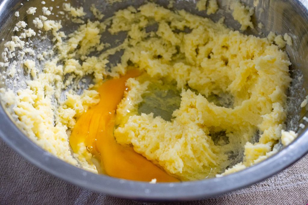 An egg added to fluffy butter mixture.