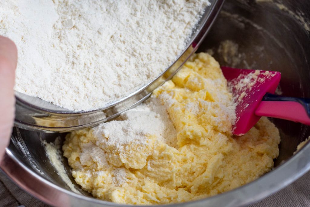 Adding dry ingredeints to the butter mixture.