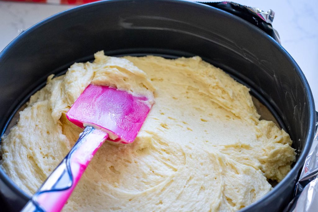 Spreading the cake mixture in a springform cake pan.
