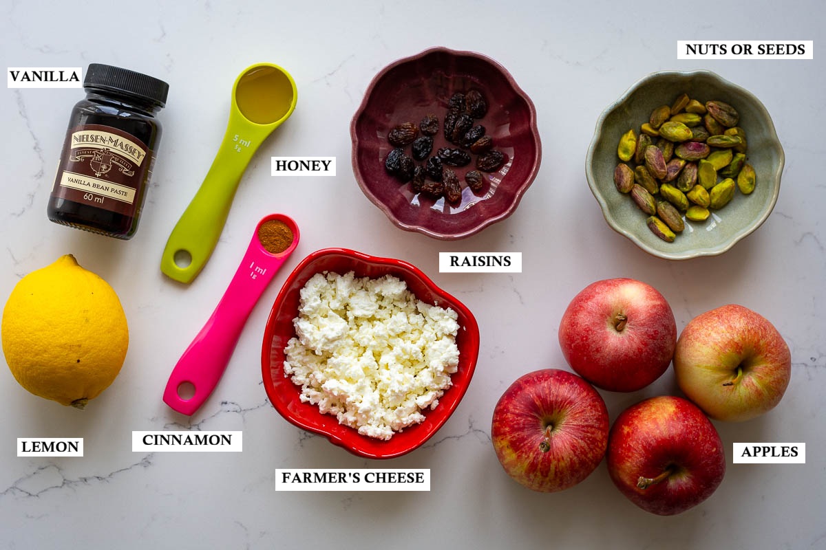Labelled ingredients for Lithuanian baked apples on a light quartz kitchen worktop.