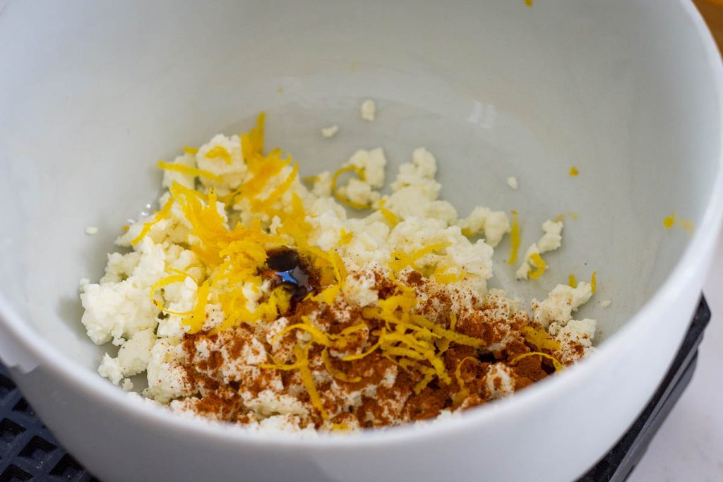 Ingredients for farmer's cheese filling for baked apples in a white bowl.