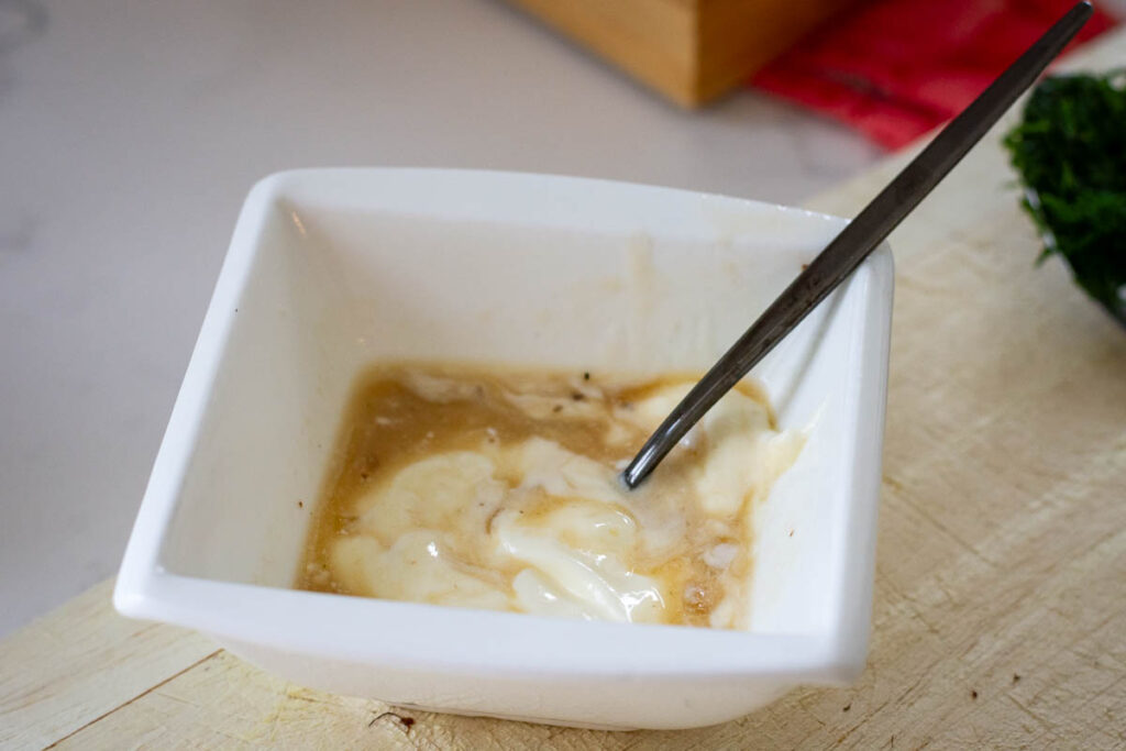 Stirring sour cream with the soup liquid. 