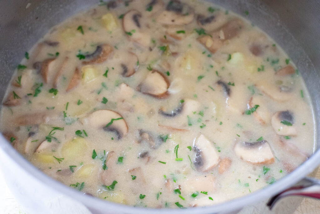 The sour cream stirred into the Lithuanian mushroom soup. 