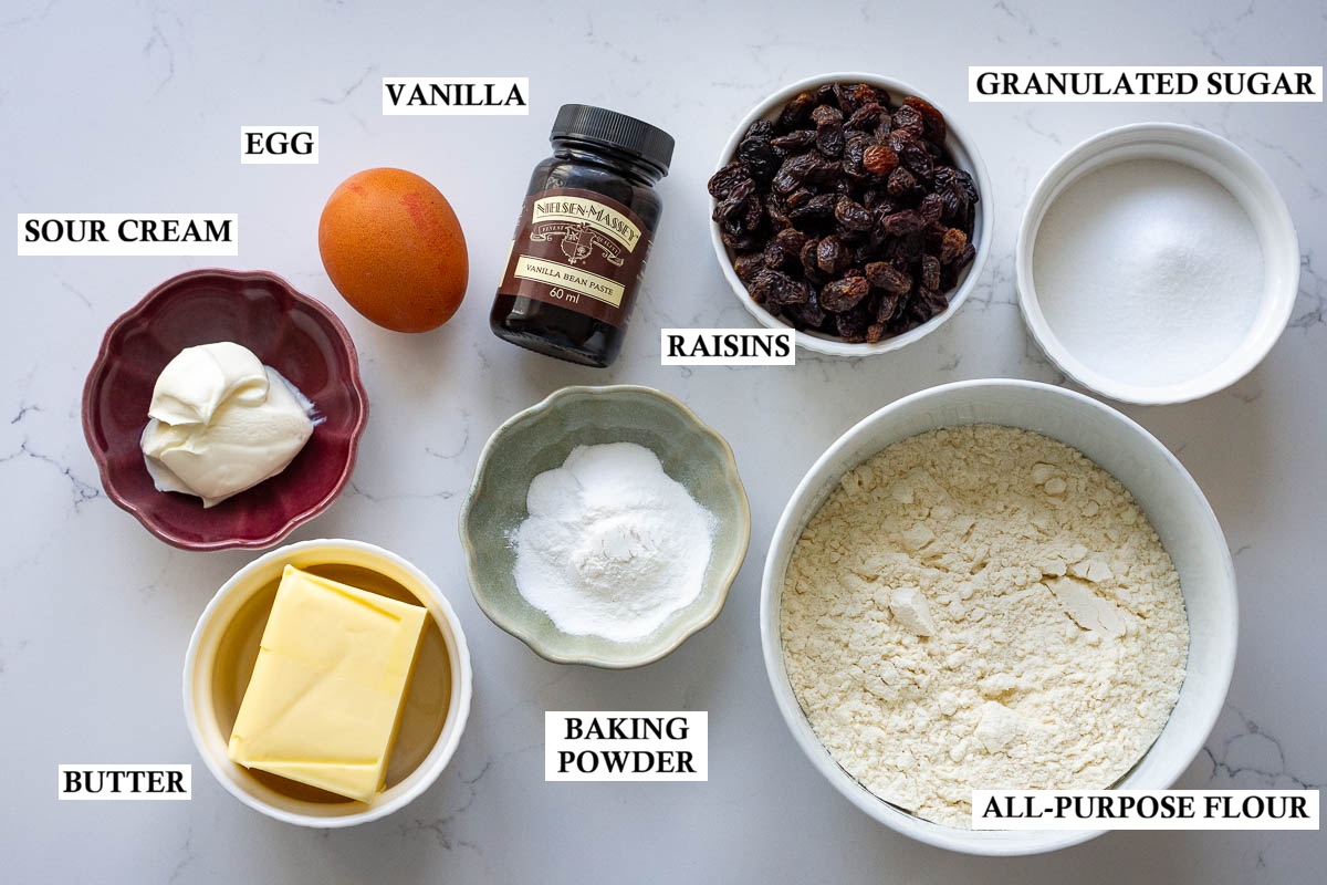Labeled ingredients for Lithuanian Rock cakes on a light kitchen surface.